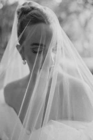 A series of ethereal black and white bridal portraits showing a delicate veil flowing in soft focus.
