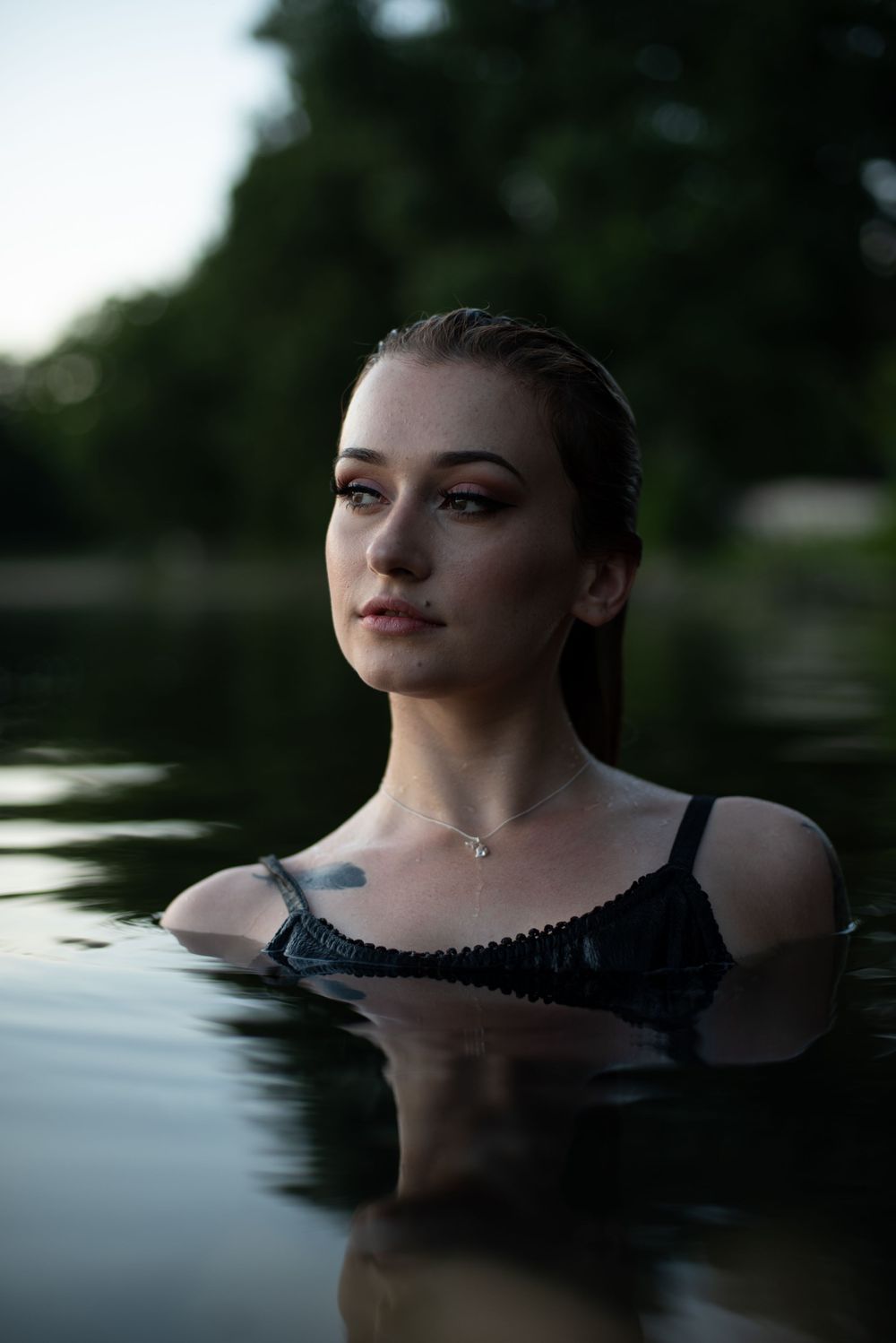 Girl with wet hair modeling in a lake