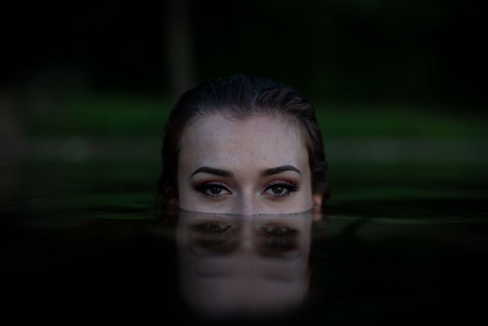 Girl with half of her face underwater