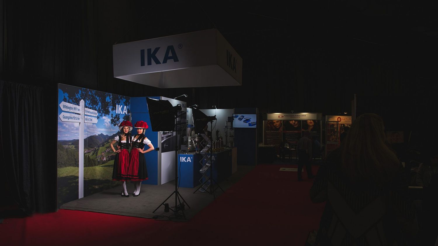IKA company booth with red carpet entrance at night event.