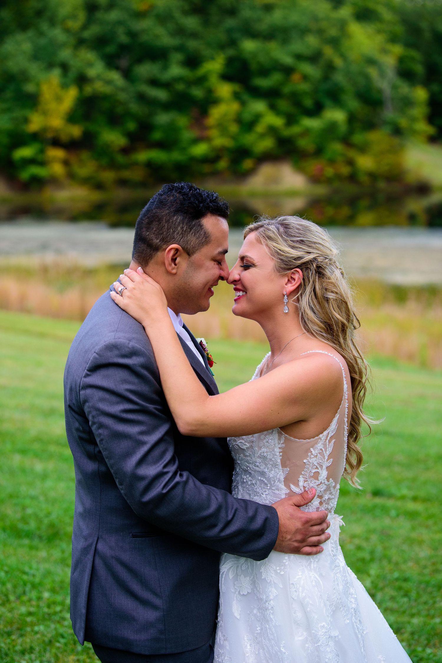 A wedding photo series showing tender moments between a couple dancing in a natural outdoor setting.
