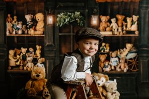 Vintage themed photo with teddy bear collection display in wooden cabinet.