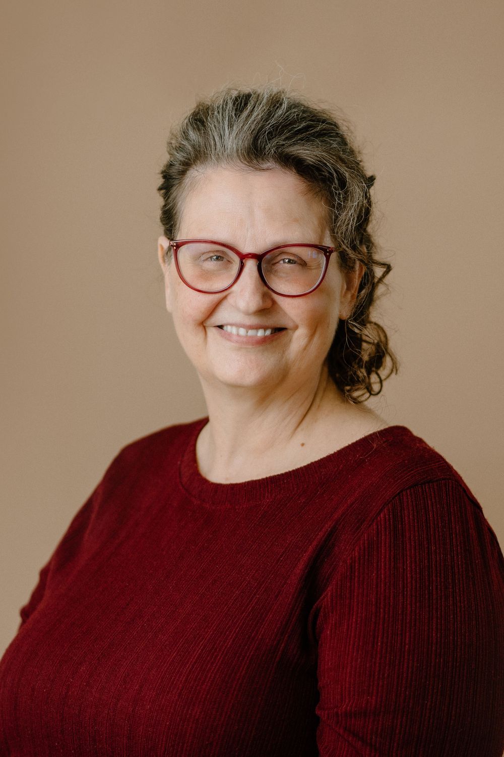Professional Headshot in an office of a woman in her 50s. Delaware Headshot Photographer