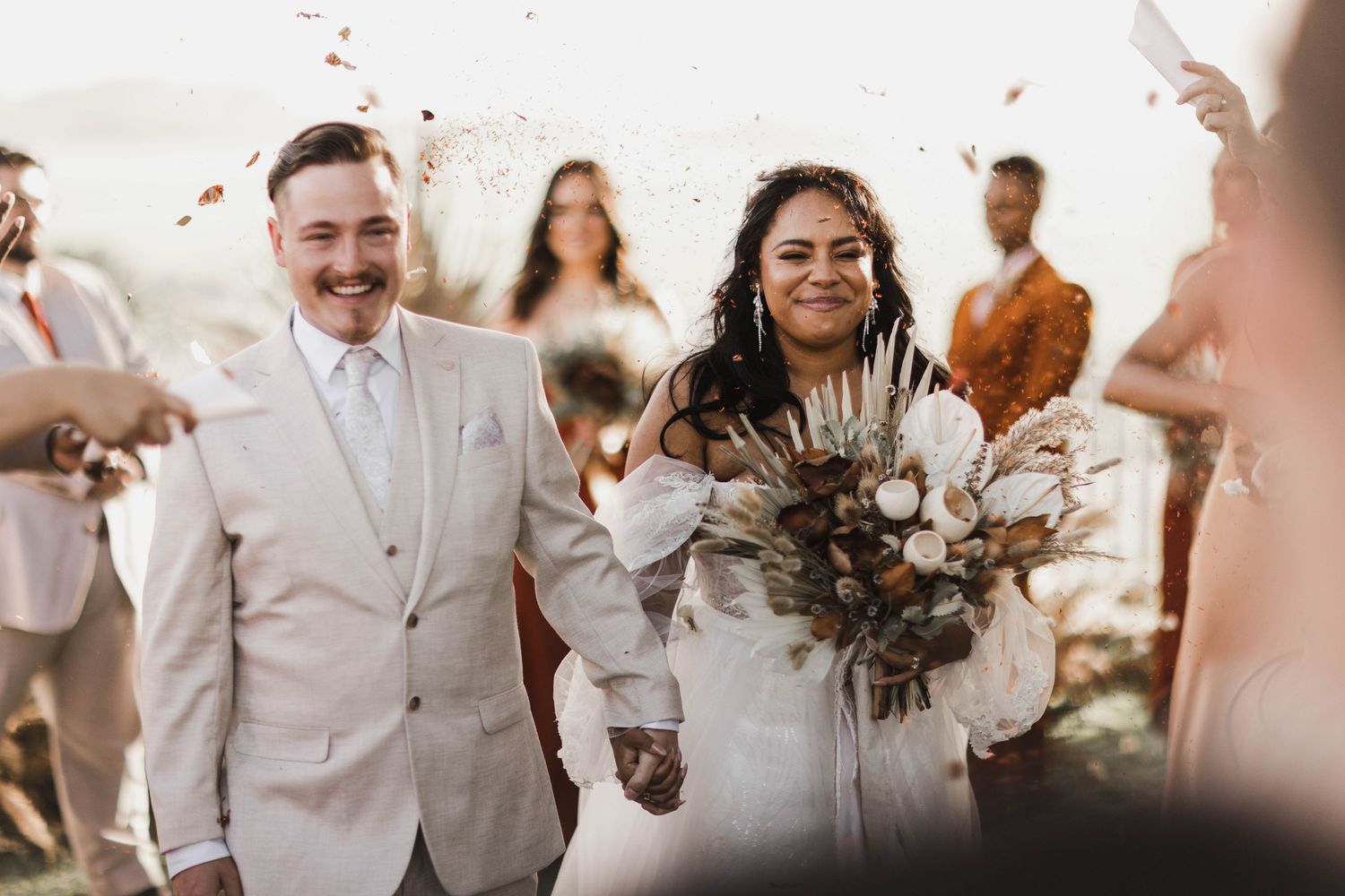 Brisbane and groom walking down aisle with confetti