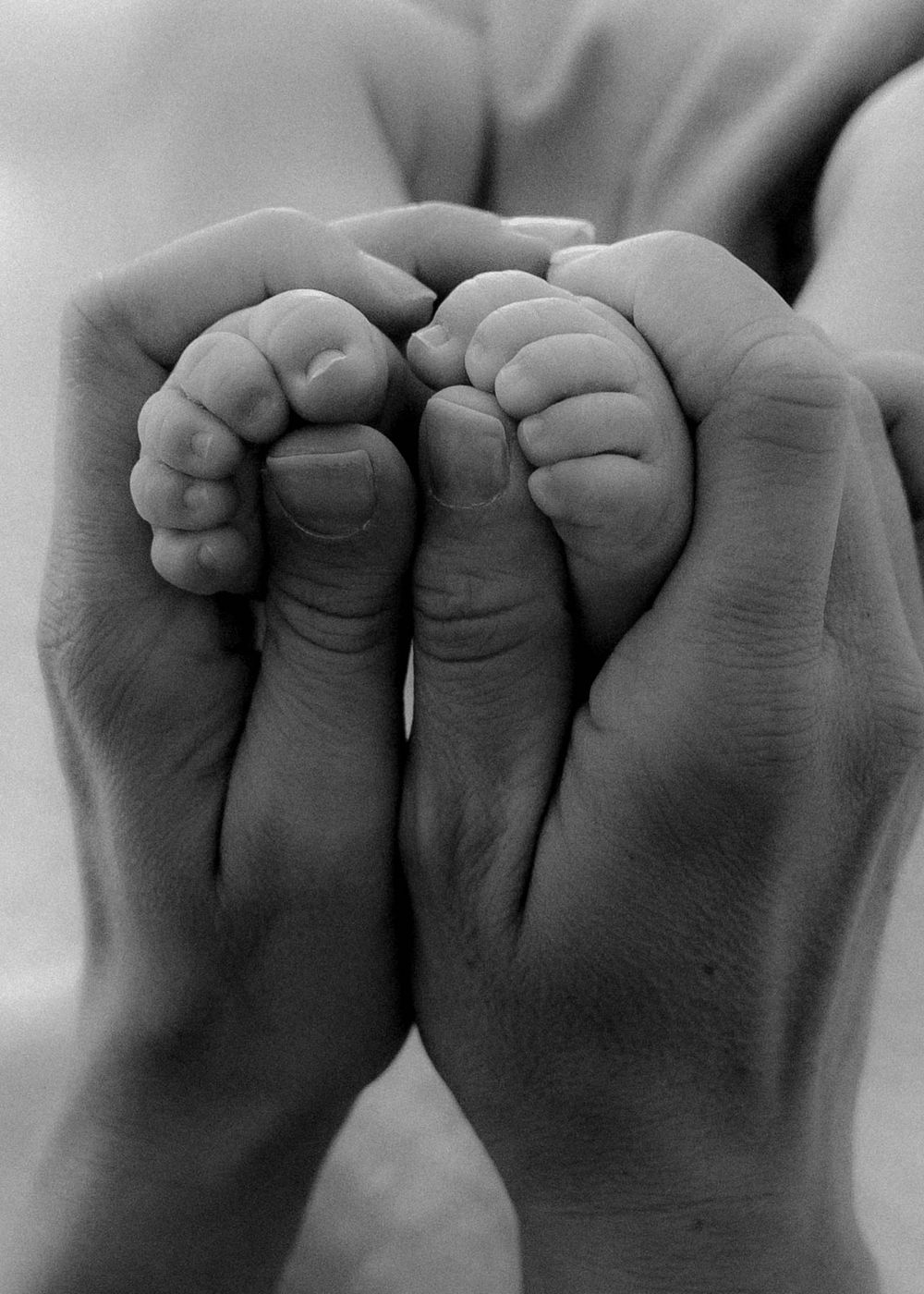 Newborn baby feet on a plush sheepskin rug, bathed in natural light during an in-home newborn photoshoot in Wollongong.