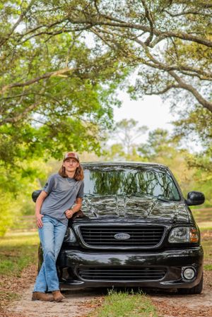 senior with his truck during fun candid senior portrait photoshoot Panama City Florida
