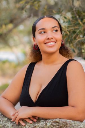 senior looking off in park during fun candid senior portrait photoshoot in Panama City Beach Florida