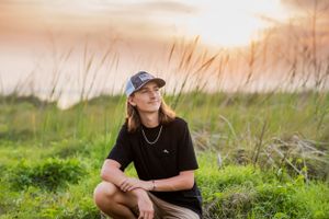 senior posing with the sunset during fun candid senior portrait photoshoot Panama City Florida
