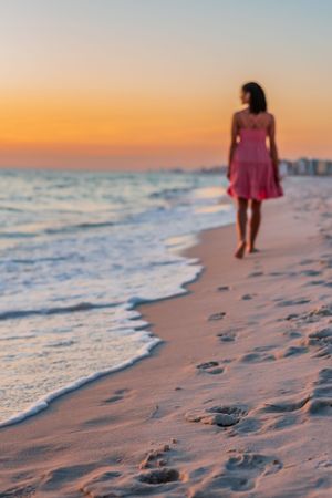 senior walking on the sand of Panama City Beach Florida during fun beach senior portrait photoshoot