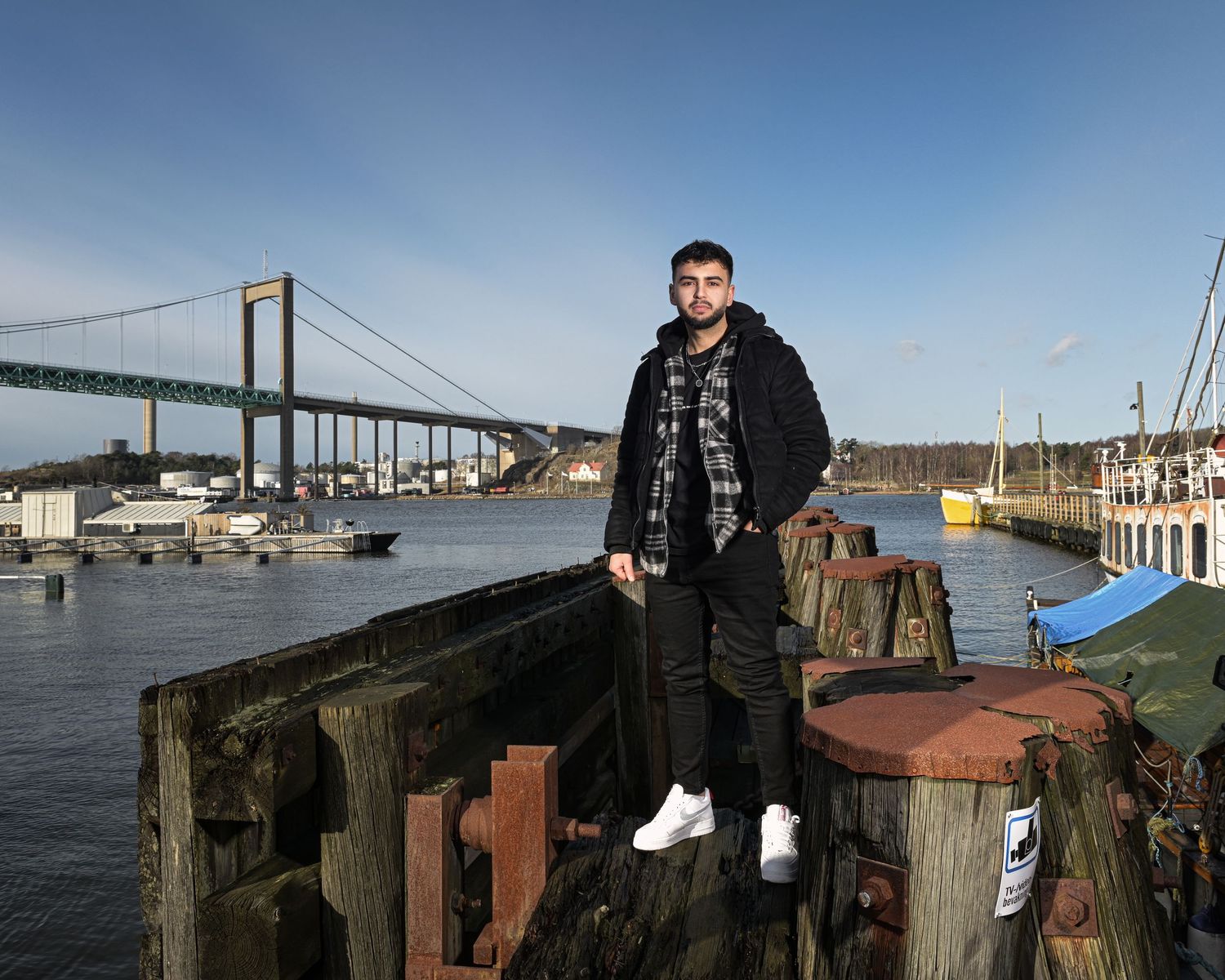 Waterfront photo series with wooden pier posts and bridge in background.