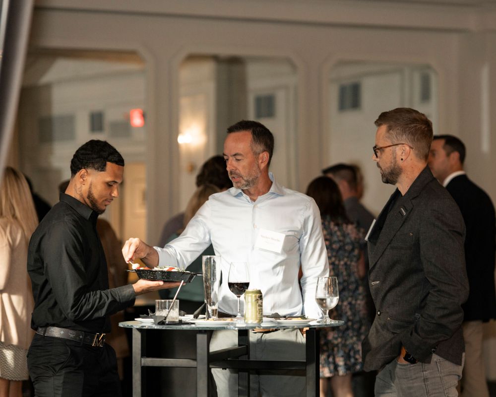Evening dining scene with casual conversation around an elegant table setting.