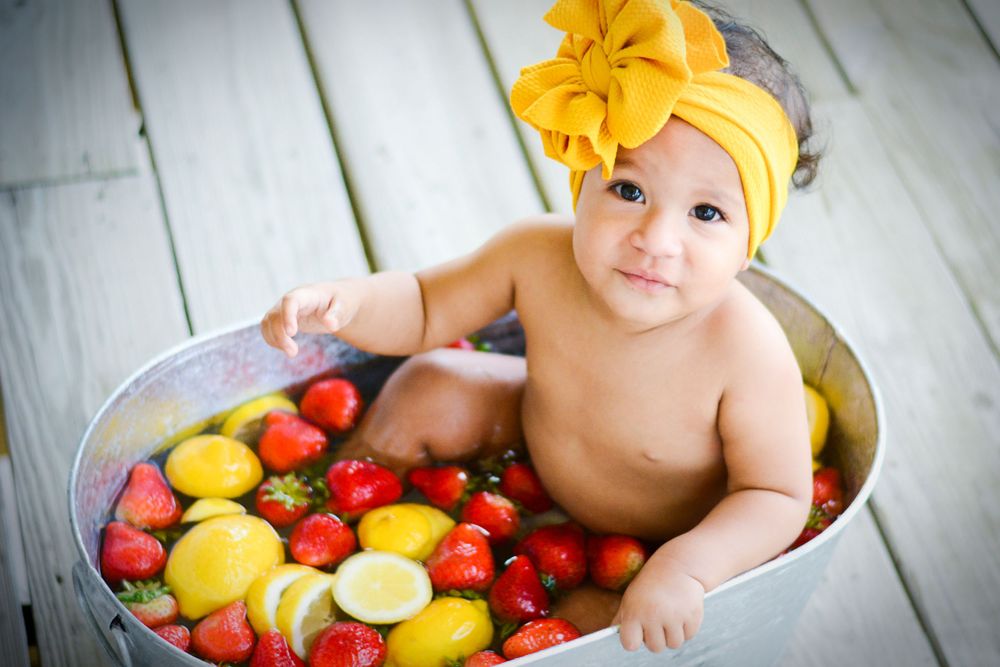 baby girl in fruit bathtub