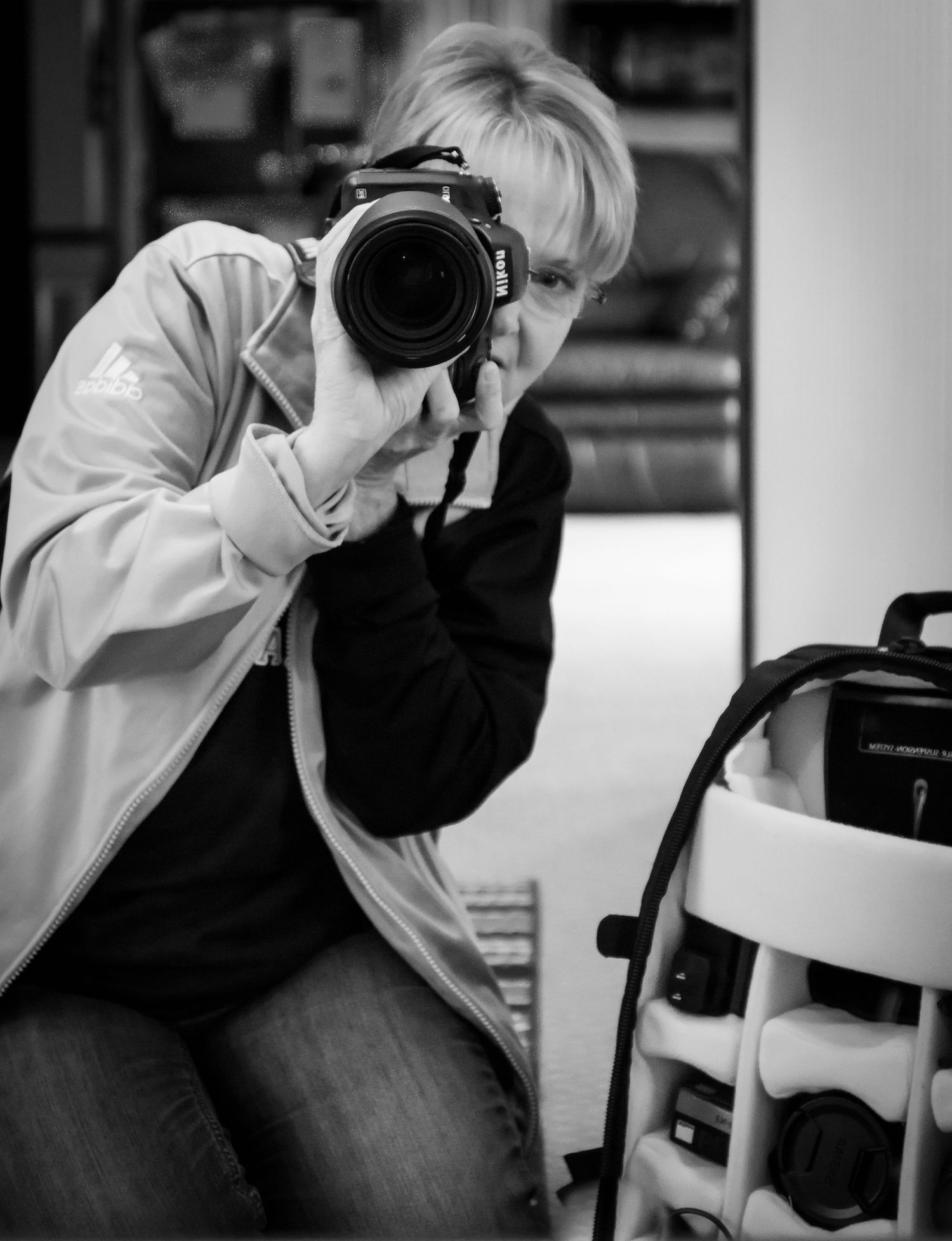 Black and white image of Tanya Lillie holding her camera