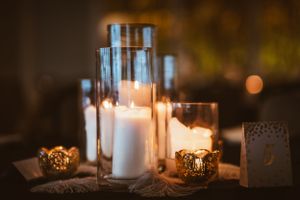 Glowing candles in glass holders creating romantic ambient lighting.
