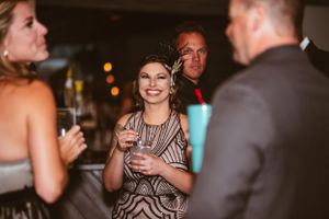 Guests enjoying drinks and conversation at an elegant evening party.