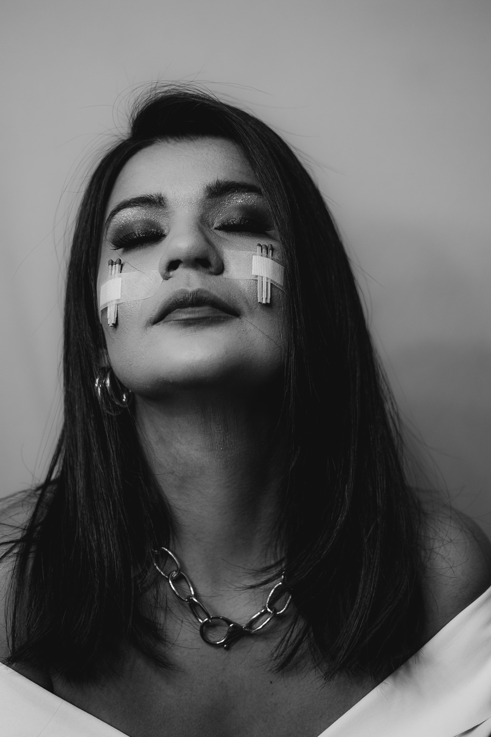 Dramatic black and white portraits showcasing edgy makeup and metallic accessories.