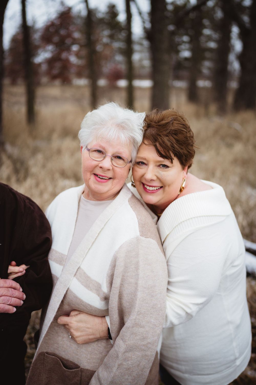 Two people sharing a cheerful moment together outdoors in winter setting.