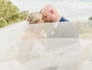 Dreamy veil-filtered wedding portrait capturing romantic moment.