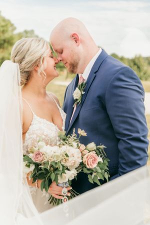 Intimate wedding portrait with couple sharing tender moment.