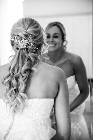 Black and white photo of bridal hairstyle with delicate floral accessories.