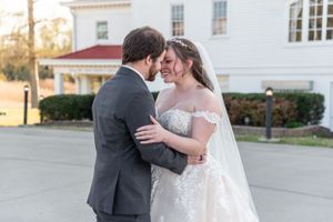 Intimate wedding moment between couple outside during golden hour.