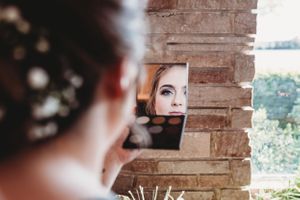 A reflection in a mirror showing preparations for a wedding day.
