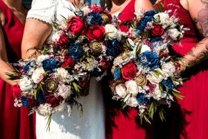 Wedding bouquets featuring red, white and blue flowers with rustic details.