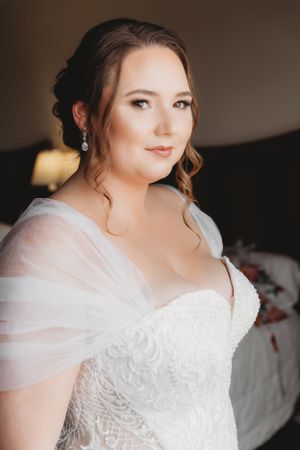 Elegant bridal portrait featuring classic white wedding gown with delicate lace details.
