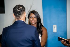 Close up of wedding ceremony moment with couple exchanging vows.