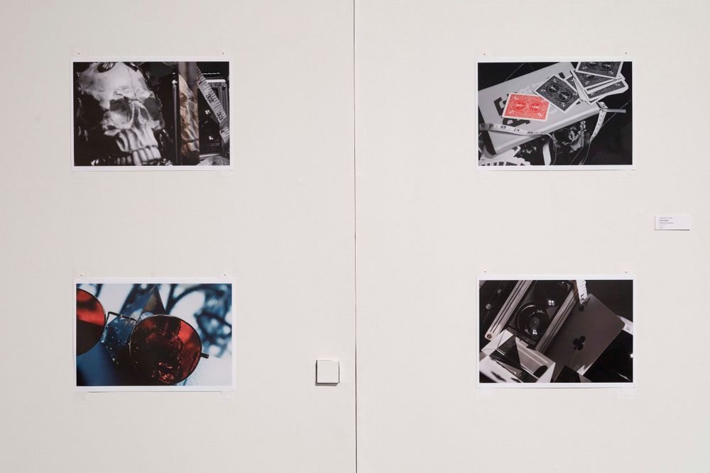 Gallery wall featuring photographs of technological devices and urban environments.