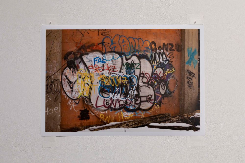 Urban wall covered in colorful graffiti art and street paintings.