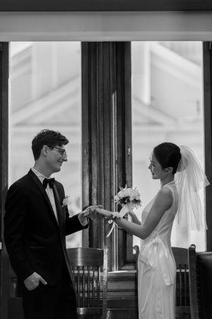 Black and white sequence of wedding moments through window frames.