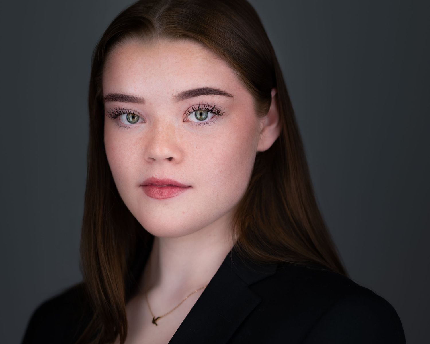 Artistic headshots with dramatic lighting against a dark background.