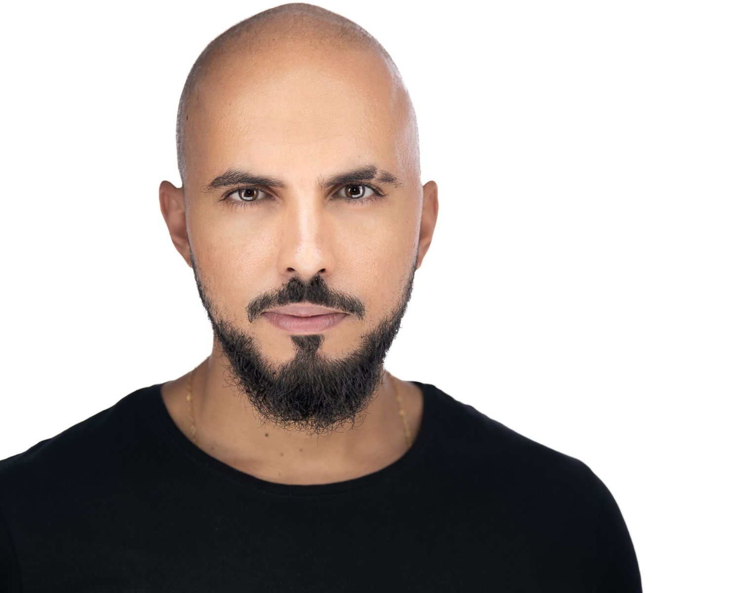 Portrait of person wearing black shirt against neutral background.
