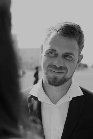 Close-up black and white portrait of groom showing various expressions.
