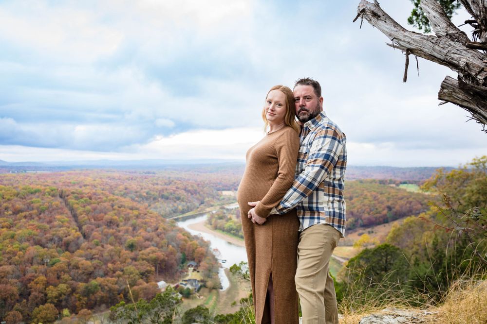Couple's maternity shoot overlooking autumn landscape in Mountain Home, Arkansas.