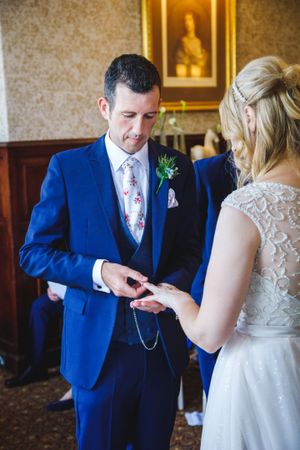 A Bride and Groom exchanging rings at their Wedding in Crewe, Cheshire. Venue is Rookery Spa Hotel.