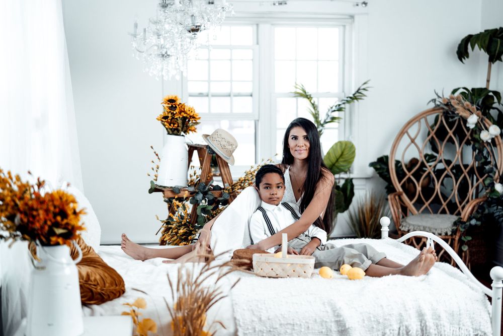 Cozy indoor photography session with autumn decor and natural lighting.