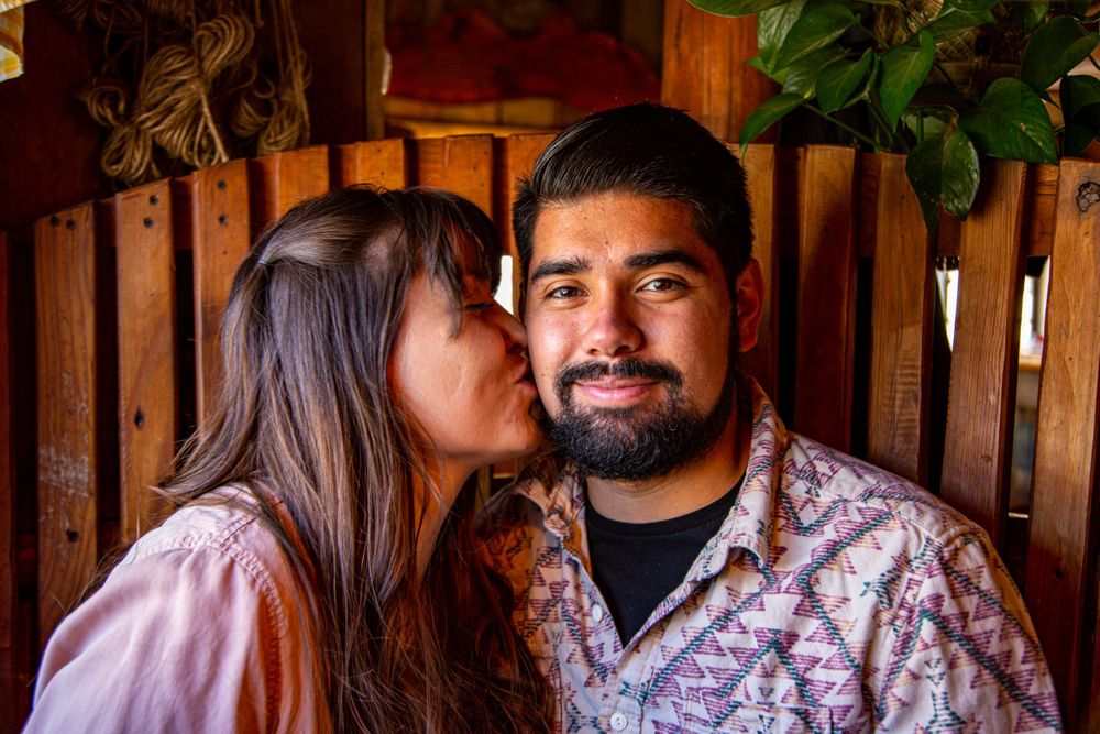 Romantic moment captured in wooden cabin interior with warm lighting.
