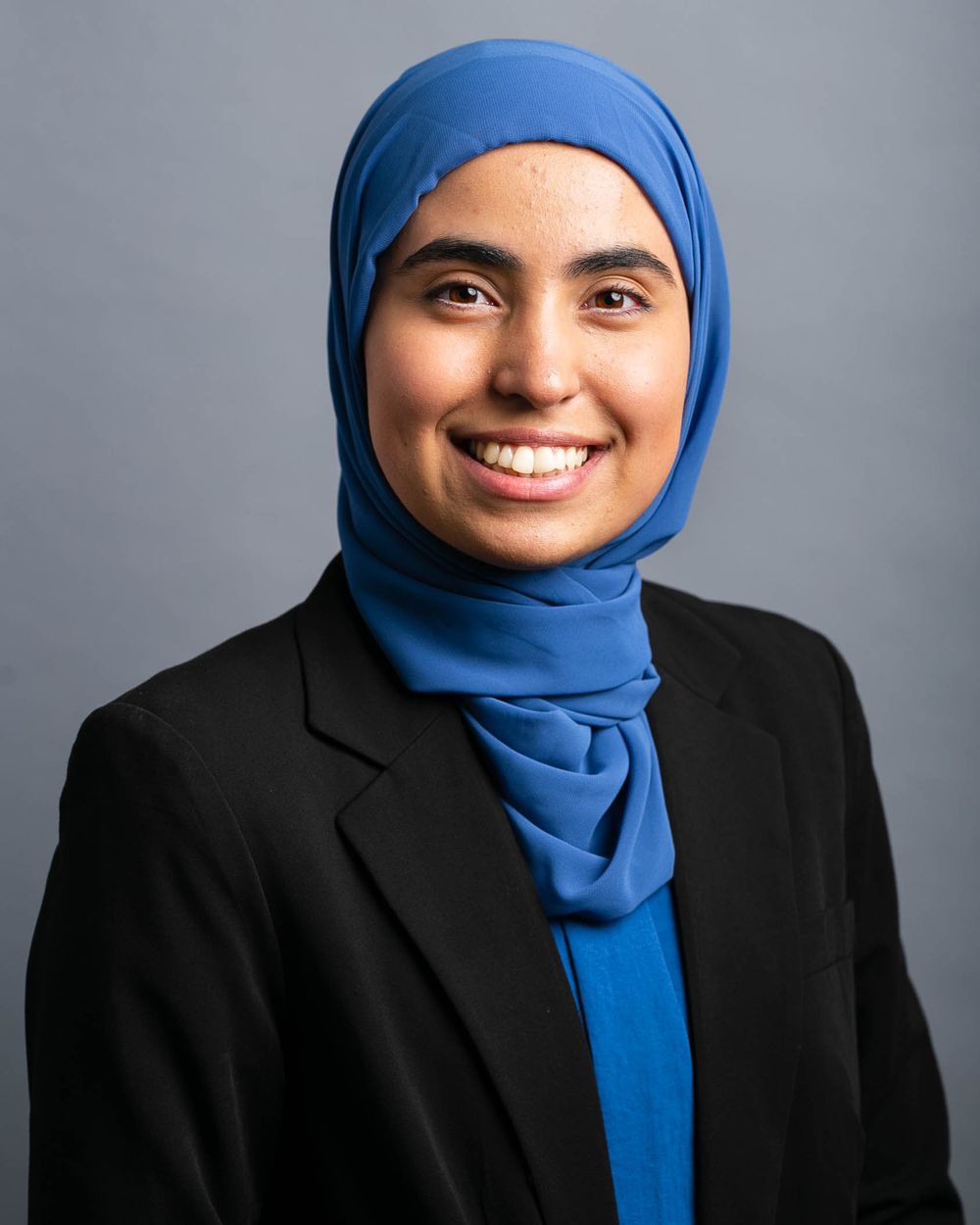 Everett WA headshot photographer: A woman wearing a headscarf, smiles for the camera