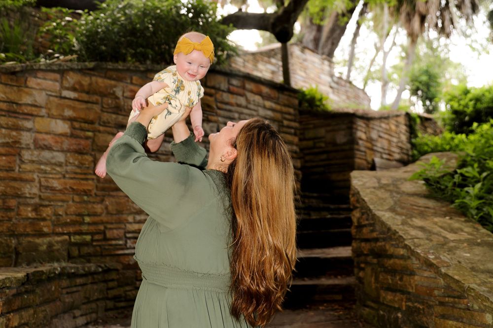 Mom and Baby Outdoor Portrait | Joyful Nature-Inspired Photography

A radiant moment as a mother in a green dress joyfully poses with baby