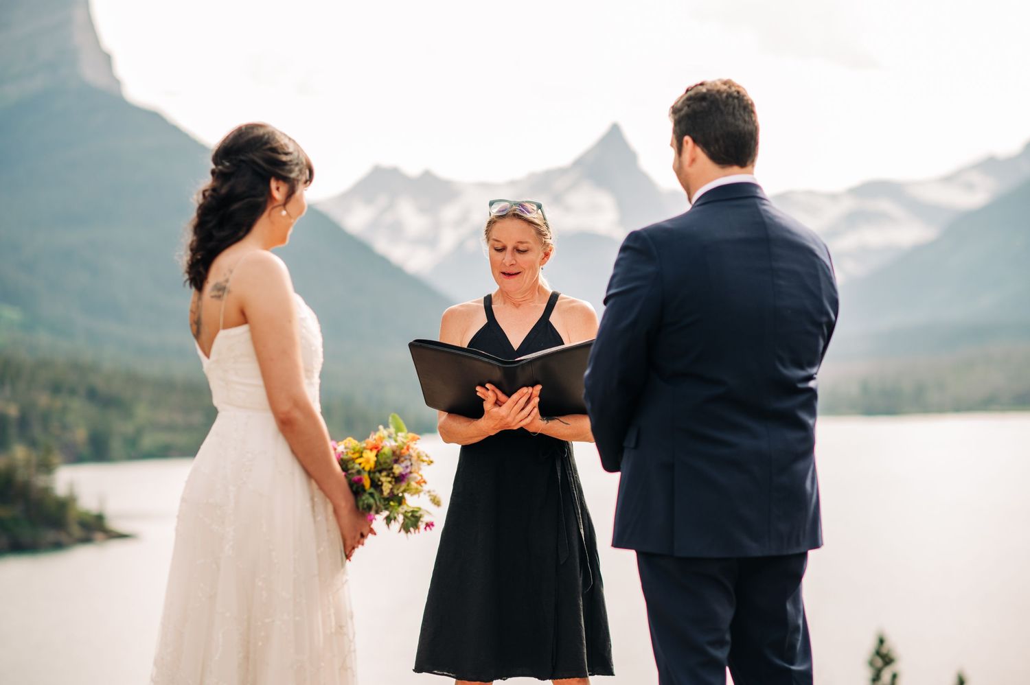 couple getting married at sun point in glacier national park