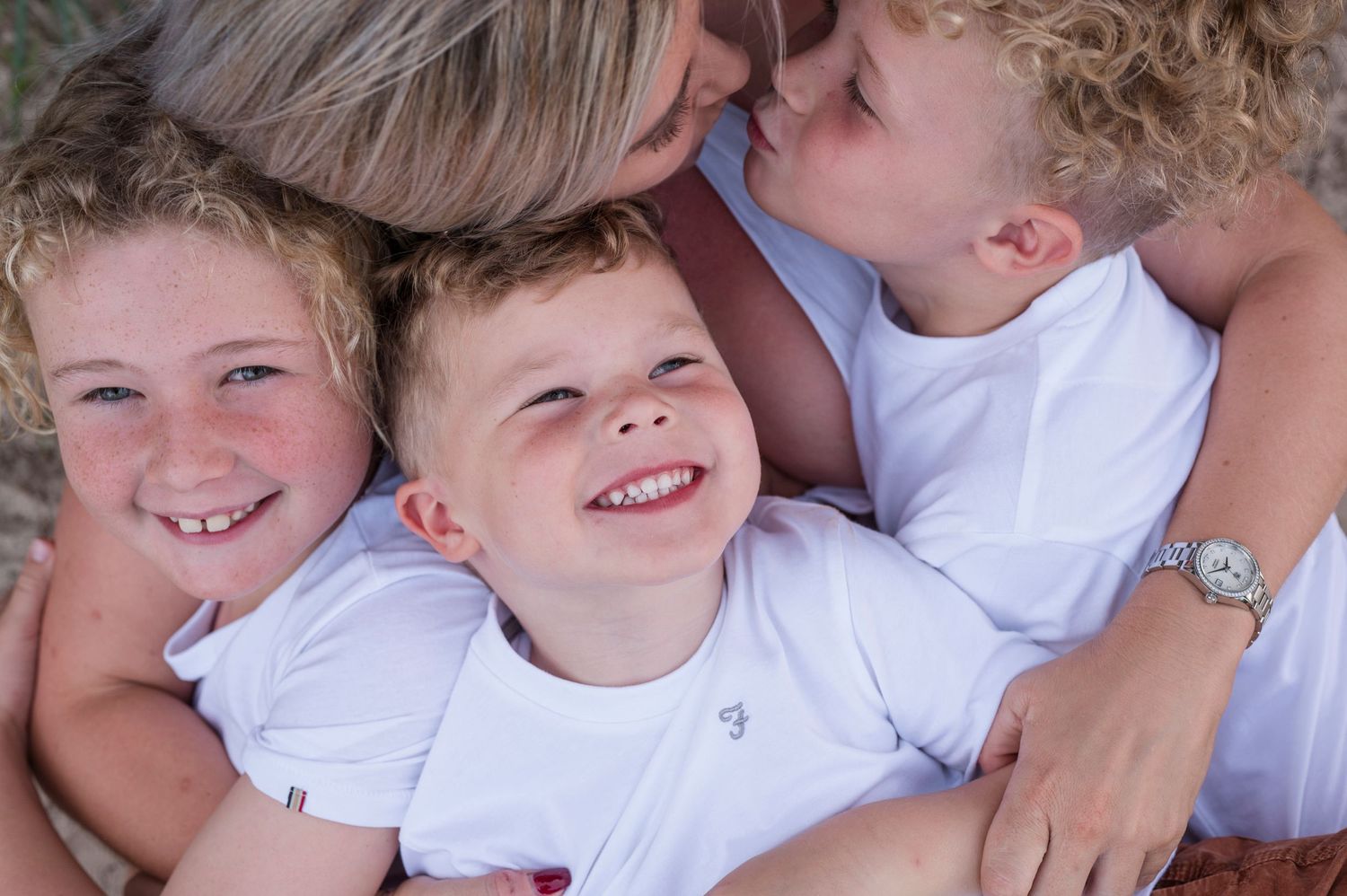 Intimate family moment captured with children sharing joyful expressions.