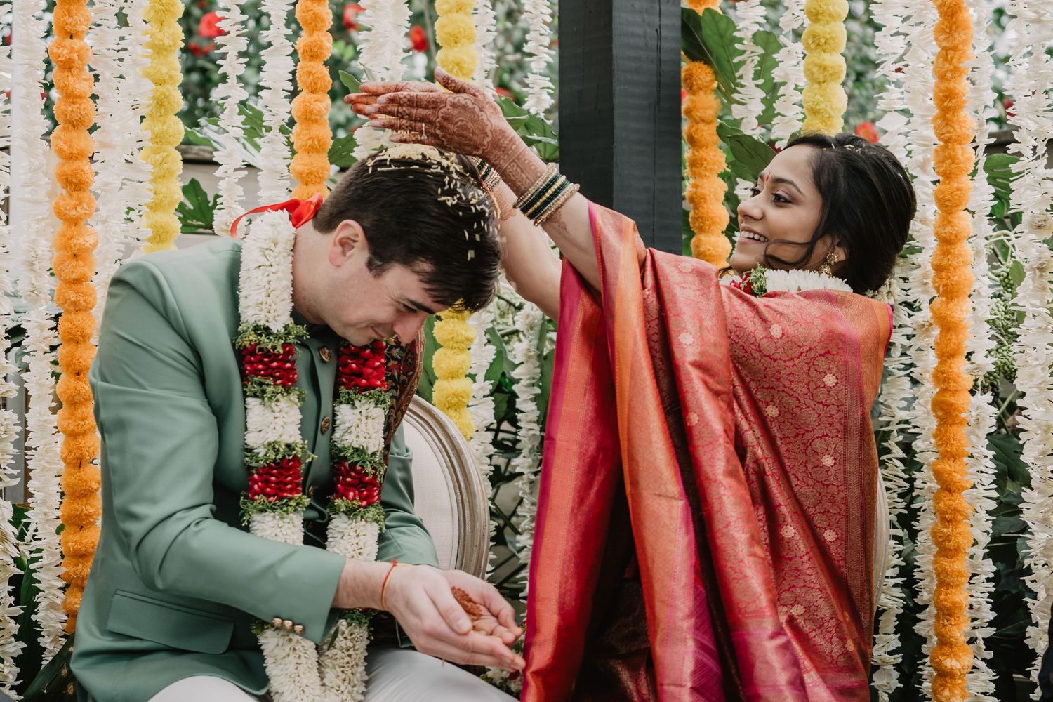 bride drops rice on the head of the groom