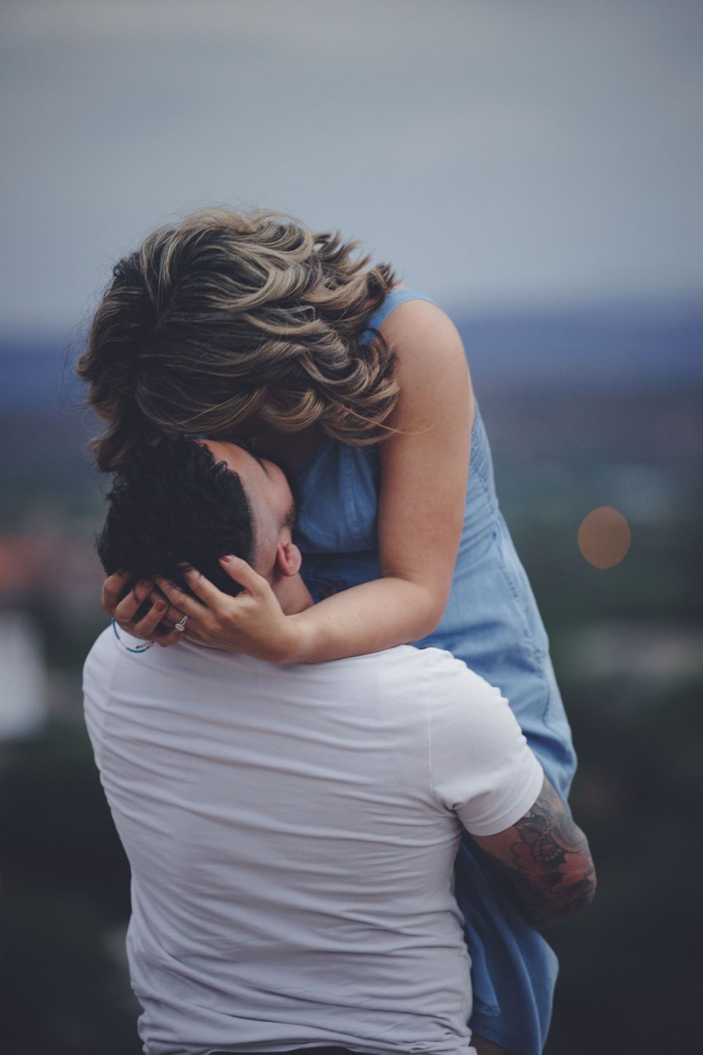 Couple embraces one another during an engagement photo session.