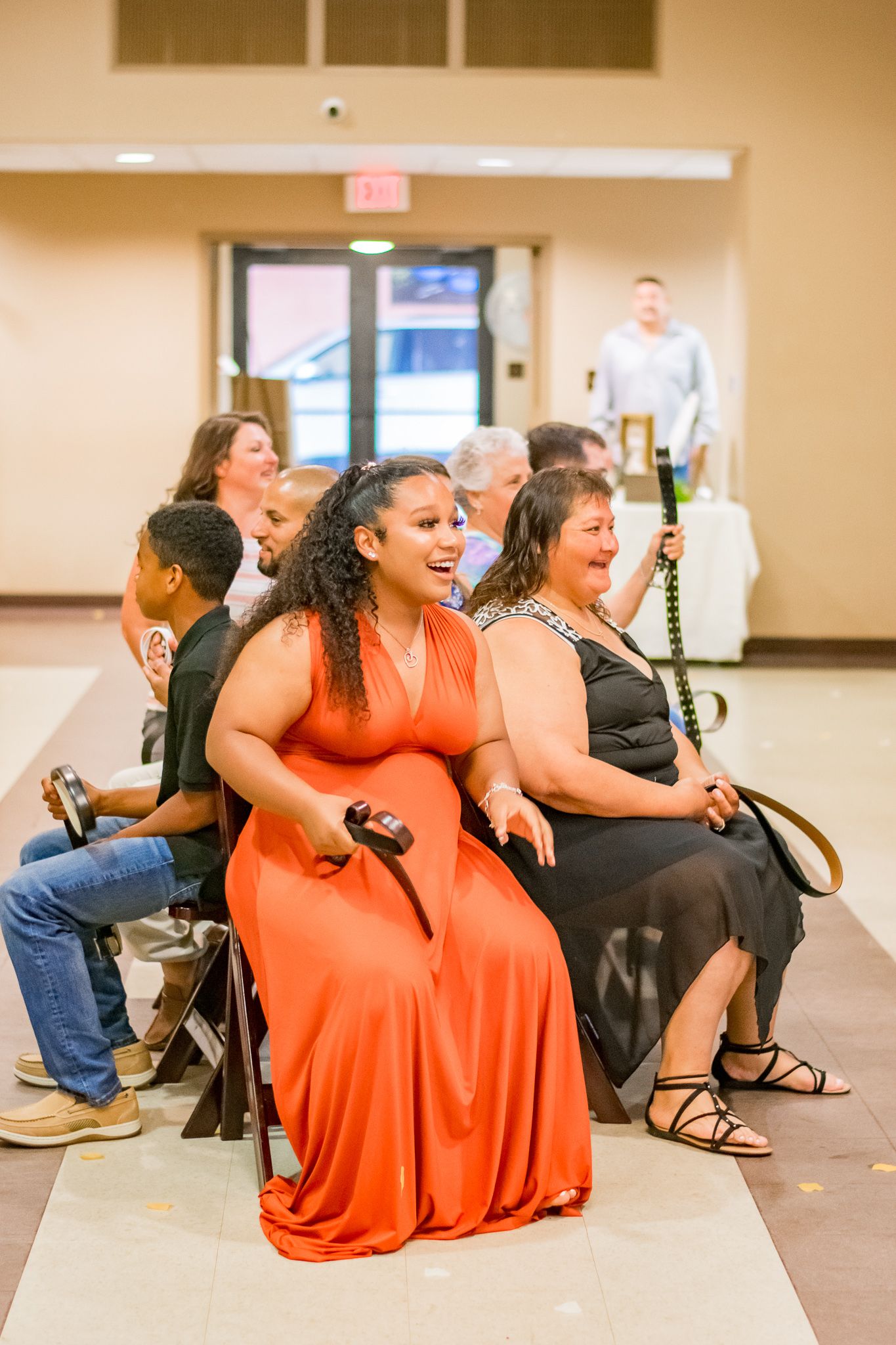Wedding guests in vibrant attire enjoying entertainment during the reception.
