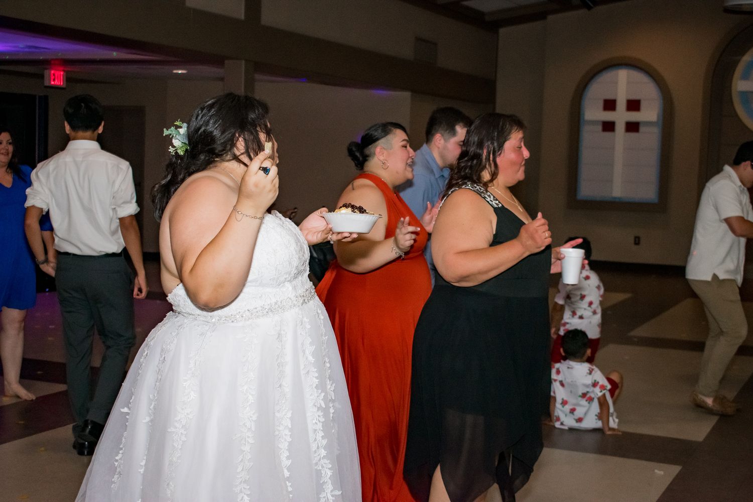 Wedding guests dancing and celebrating during the reception.
