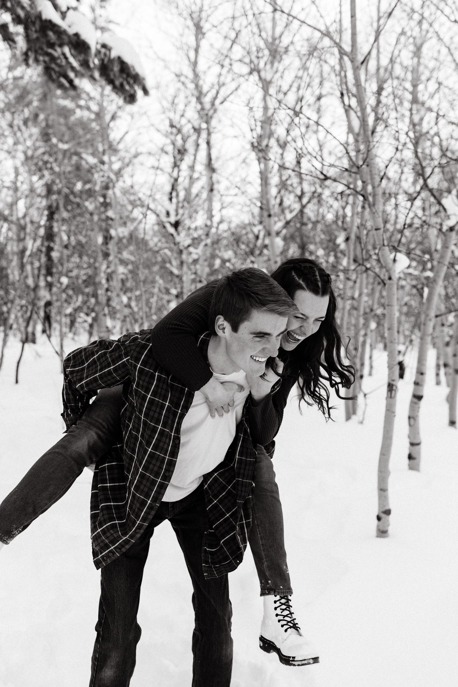 Back and White Couple Piggy Back Snow Woods