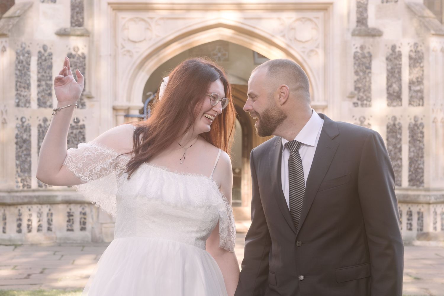 Newlywed bride and groom holding hands and looking at each other after their wedding at Chelmsford Registry Office