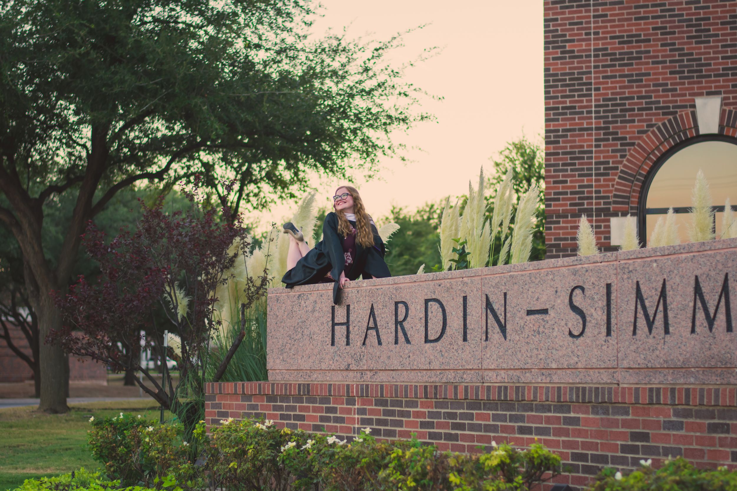 A brick entrance sign for Hardin-Simmons University senior graduation portrait session